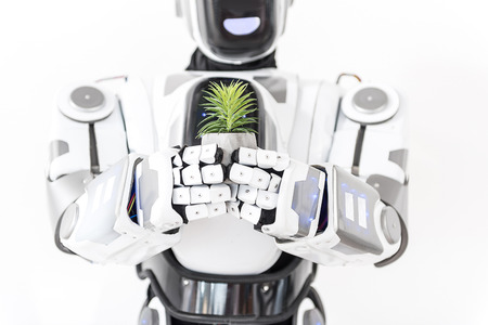 Cyborg keeping small green plantの写真素材