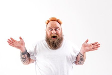 Excited thick male hipster having fun with meatの写真素材