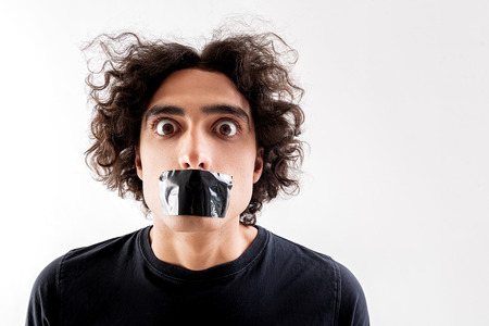 Scared guy with scotch tape on lipsの写真素材