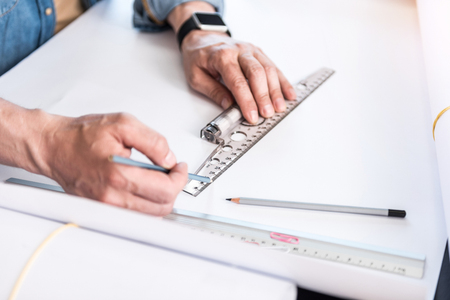 Employee making straight lines on paperの写真素材