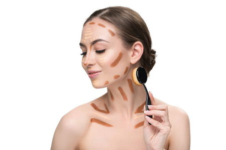 Happy smiling attractive woman doing make-upの写真素材