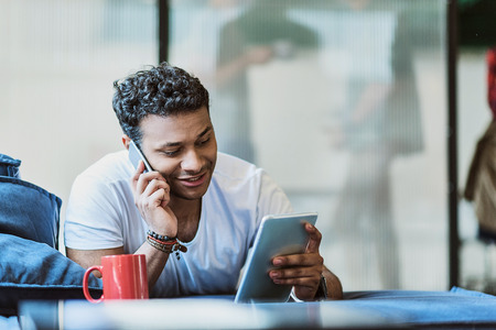 Cheerful male freelancer using modern technologyの写真素材