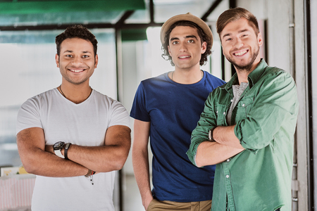 Joyful male colleagues are proud of their workの写真素材