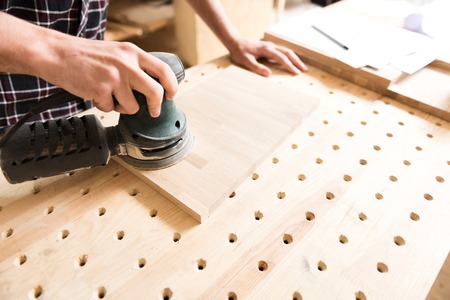 Joiner is working carefully with instrumentの写真素材