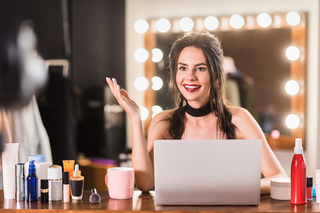 Confident young woman recording video in dressing roomの写真素材