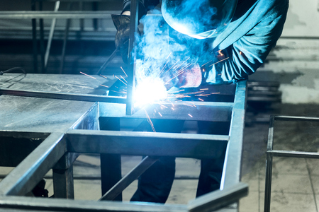Professional experienced laborer is leaning on his workplace