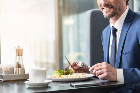 Happy man dining in cafeの写真素材