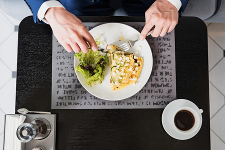 Man having lunch in cafeの写真素材