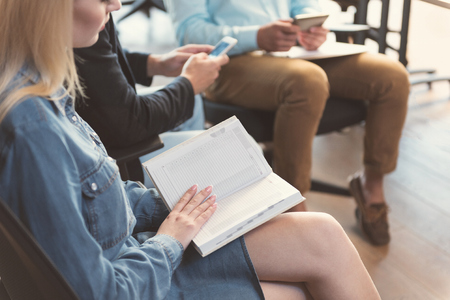 Youthful woman is planning her day while waiting for interviewの写真素材