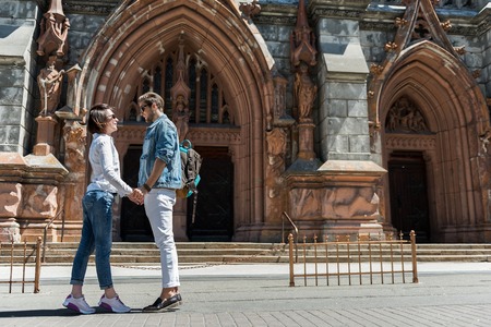 Cheerful youthful couple observing together city sightsの写真素材