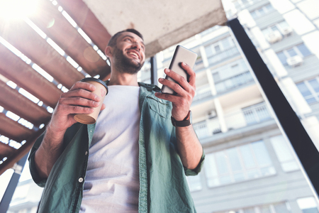 Joyful adult man is enjoying espressoの写真素材