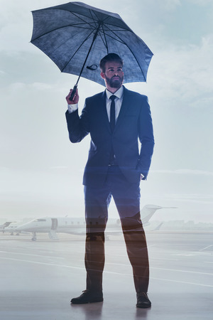 Successful male manager posing near aircraftsの写真素材