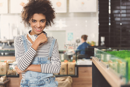 Cheerful modern girl is making purchases in vegan storeの写真素材