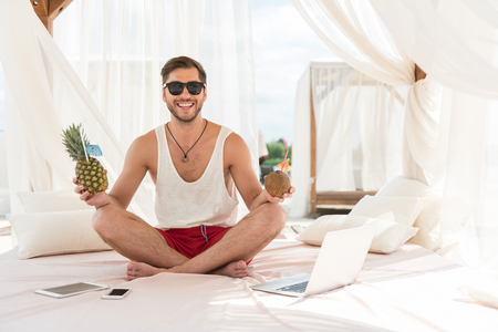Jolly young bearded guy resting on summer resortの写真素材