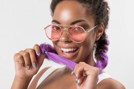 Happy african girl is holding her kanekalon hair braidsの写真素材