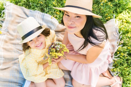 Happy mom and child with meadow flowersの写真素材