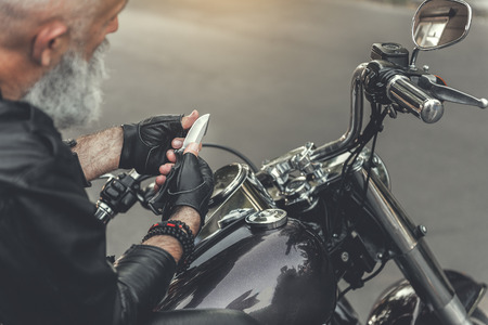 Aged man holding sharp bladeの写真素材