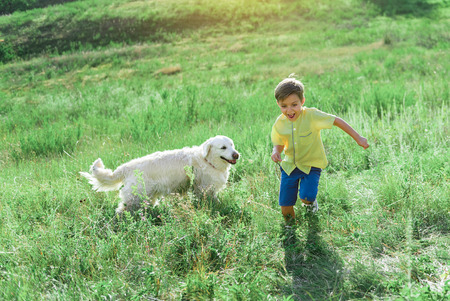 Child enjoying happy moments with favorite pet