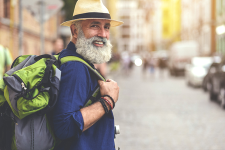 Excited senior male traveler enjoying walk in townの写真素材