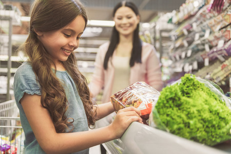 Curious smiling child in storeの写真素材