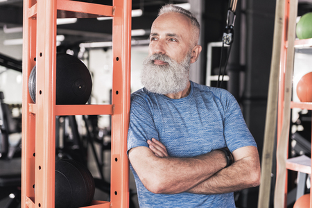 Old male with beard is resting in athletic clubの写真素材