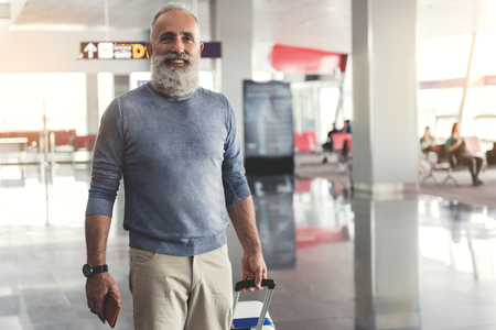 Happy smiling man in airportの写真素材