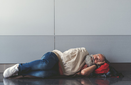 Happy smiling old man lying on floor