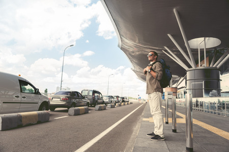 Happy man is waiting for car