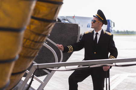 Assured aviator standing near planeの写真素材