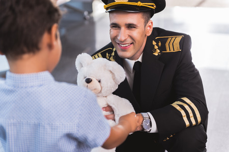 Happy smiling airman presenting toyの写真素材