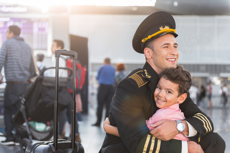 Joyful aviator hugging his sonの写真素材
