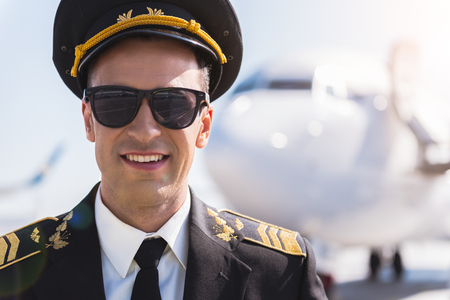 Happy smiling airman glancing ahead