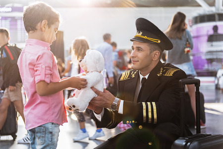 Little boy taking toy from father aviartorの写真素材