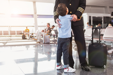 Small male person hugging father aviatorの写真素材