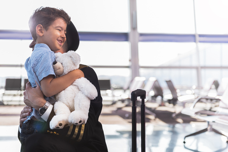 Pilot hugging little smiling sonの写真素材