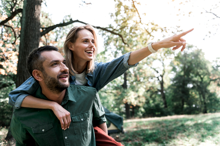 Happy loving couple enjoying natural view in forestの写真素材