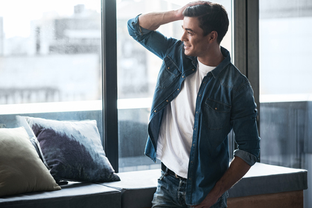 Cheerful young man is enjoying viewの写真素材