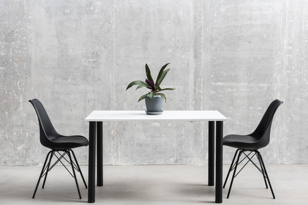 Table and chair situating in roomの写真素材