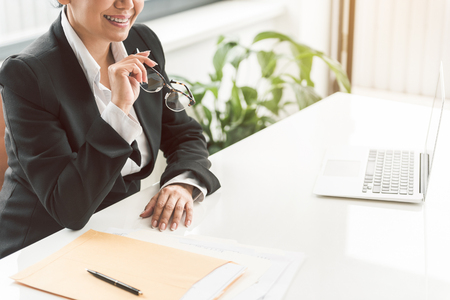 Outgoing businesswoman locating at deskの写真素材