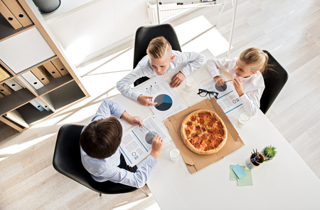 Skillful smart kids are acting as business peopleの写真素材