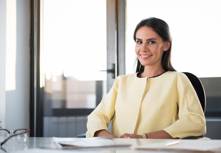 Positive cute businesswoman is expressing happinessの写真素材