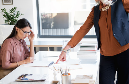 Lady boss is demonstrating dissatisfaction of her assistant workの写真素材