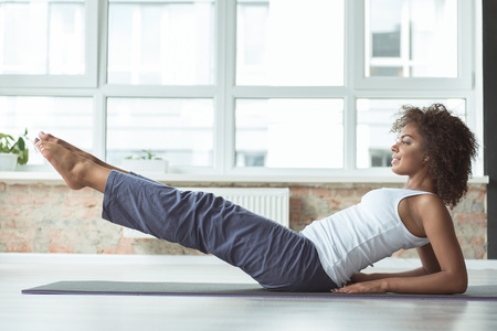 Outgoing woman working out on matの写真素材