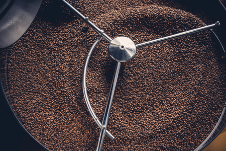 Top view close up aromatic coffee beans situating in spinning cooler professional machine. Arabica conceptの写真素材