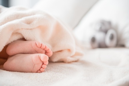 Close up of sweet newborn infant taking rest in apartment. Copy space in right sideの写真素材