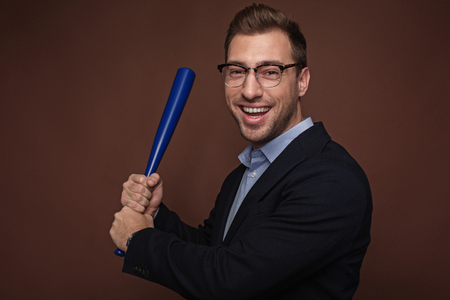 Portrait of laughing unshaven male keeping bat in arm. Protection and work concept. Isolatedの写真素材