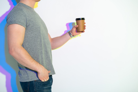 Close up man hand holding cup of delicious beverage. Rest concept. Copy spaceの写真素材
