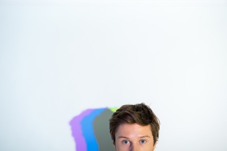 Half face of calm man watching at camera. Contemplative concept. Copy spaceの写真素材