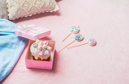 Top view pink present with cake and candies locating on rug. Dessert conceptの写真素材