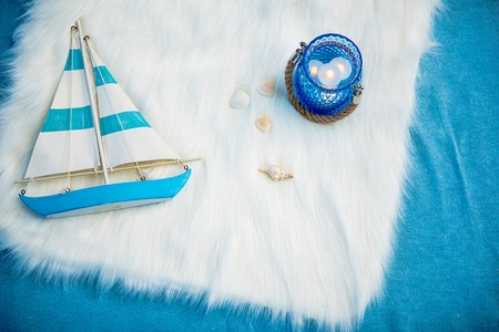 Top view toy ship, and candle locating on soft carpet. Coastal theme decoration conceptの写真素材